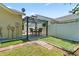 Backyard showcasing a patio with a dining area, turf, and white vinyl fence at 1007 Autumn Dr., Murrells Inlet, SC 29576