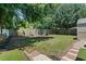 Large backyard featuring a wood fence, manicured lawn, and patio area, perfect for outdoor entertaining at 1007 Autumn Dr., Murrells Inlet, SC 29576