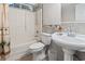 Bathroom featuring a combination tub and shower, a pedestal sink, and a flower as a decorative touch at 1007 Autumn Dr., Murrells Inlet, SC 29576
