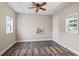 Cozy bedroom featuring modern wood flooring, two windows and a ceiling fan at 1007 Autumn Dr., Murrells Inlet, SC 29576