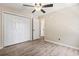 Bedroom boasts a ceiling fan, wood-look floors, and closet space, providing functionality and style at 1007 Autumn Dr., Murrells Inlet, SC 29576