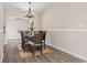 Elegant dining room featuring modern wood flooring, stylish chandelier and neutral walls at 1007 Autumn Dr., Murrells Inlet, SC 29576