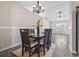 Elegant dining room featuring modern wood flooring, stylish chandelier and a view into the living room at 1007 Autumn Dr., Murrells Inlet, SC 29576