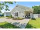 Charming one-story home featuring a landscaped front yard and inviting front porch seating at 1007 Autumn Dr., Murrells Inlet, SC 29576