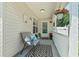 Inviting front porch area with a cozy chair, patterned rug and hanging flower basket at 1007 Autumn Dr., Murrells Inlet, SC 29576