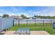 Spacious backyard featuring a large patio, lush green lawn, and black metal fence at 1036 Macala Dr., Conway, SC 29526