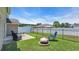 Backyard with green grass, black metal fence, patio furniture, and a fire pit at 1036 Macala Dr., Conway, SC 29526