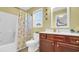 Bathroom with wood vanity, white countertop, large mirror, and shower with decorative curtain at 1036 Macala Dr., Conway, SC 29526