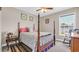 Bright bedroom features a four-poster bed, ceiling fan, and a window with a view at 1036 Macala Dr., Conway, SC 29526