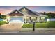 Charming single-story home featuring a manicured lawn, attached garage and inviting front porch at 1036 Macala Dr., Conway, SC 29526