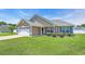 Attractive single-story home with an attached garage, manicured lawn, and charming entryway at 1036 Macala Dr., Conway, SC 29526