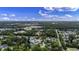 Overhead view of a neighborhood nestled among mature trees with a community pond at 104 Ashton Circle, Myrtle Beach, SC 29588