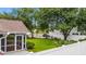 Exterior features well-manicured lawn, fenced-in yard, screen patio, and mature trees at 104 Ashton Circle, Myrtle Beach, SC 29588