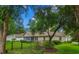 View of the backyard featuring a screened in porch, black fence and mature trees offering privacy and a lush environment at 104 Ashton Circle, Myrtle Beach, SC 29588