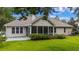 Beautiful backyard featuring a screened in porch, well maintained lawn, and an abundance of trees for shade at 104 Ashton Circle, Myrtle Beach, SC 29588