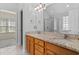 Bathroom with dual sinks, granite countertops, tile floors, and a walk-in shower at 104 Ashton Circle, Myrtle Beach, SC 29588