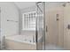 Luxurious bathroom featuring a soaking tub, glass shower, and stylish tile work at 104 Ashton Circle, Myrtle Beach, SC 29588