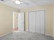 Bedroom with ceiling fan, neutral walls, plush carpeting, closet access, and natural light at 104 Ashton Circle, Myrtle Beach, SC 29588