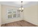 Bright dining room with hardwood floors, large windows, modern chandelier, and neutral color palette at 104 Ashton Circle, Myrtle Beach, SC 29588