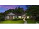 Exterior dusk shot showcases a well maintained lawn, brick and siding, and an inviting walkway to the front door at 104 Ashton Circle, Myrtle Beach, SC 29588