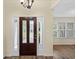 Inviting foyer featuring a beautiful wood door with glass inserts and sidelights, and hardwood flooring at 104 Ashton Circle, Myrtle Beach, SC 29588