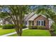 Well-maintained single-story home showcasing a brick facade and a lush front lawn at 104 Ashton Circle, Myrtle Beach, SC 29588