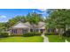 Charming brick home with manicured lawn, mature landscaping, and inviting walkway to front door at 104 Ashton Circle, Myrtle Beach, SC 29588