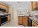 Well-lit kitchen featuring wooden cabinetry, granite counters, and stainless steel appliances at 104 Ashton Circle, Myrtle Beach, SC 29588