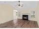 Cozy living room featuring a fireplace, ceiling fan, hardwood floors, and access to other rooms at 104 Ashton Circle, Myrtle Beach, SC 29588