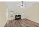 Comfortable living room with a fireplace, ceiling fan, hardwood floors, and bright windows at 104 Ashton Circle, Myrtle Beach, SC 29588