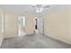 Comfortable bedroom featuring carpet, ceiling fan, and open doorway to en-suite bathroom at 104 Ashton Circle, Myrtle Beach, SC 29588