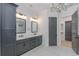 This bathroom features dual sinks, grey cabinets and drawers, and an elegant chandelier at 1054 East Isle Of Palms Ave., Myrtle Beach, SC 29579