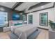 This bedroom features a ceiling fan, two large windows, wood floors and a light grey color scheme at 1054 East Isle Of Palms Ave., Myrtle Beach, SC 29579