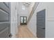 Bright foyer featuring an elegant chandelier, staircase, and front door at 1054 East Isle Of Palms Ave., Myrtle Beach, SC 29579