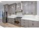 Modern kitchen featuring stainless steel appliances, gray cabinets, mosaic backsplash, and ample counter space at 1054 East Isle Of Palms Ave., Myrtle Beach, SC 29579
