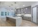 Modern kitchen with sleek gray cabinetry, stainless steel appliances, a stylish backsplash, and a large center island at 1054 East Isle Of Palms Ave., Myrtle Beach, SC 29579