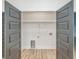 View of laundry room with modern grey doors and wood-look floors at 1054 East Isle Of Palms Ave., Myrtle Beach, SC 29579