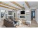 Stylish living room featuring exposed wood beams, a modern fireplace, and built-in shelving for a sleek look at 1054 East Isle Of Palms Ave., Myrtle Beach, SC 29579