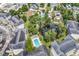 Aerial view showcasing condos with a pool, pond, mature trees, and a well-maintained community at 1058 Sea Mountain Hwy. # 102, North Myrtle Beach, SC 29582