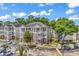 Apartment complex featuring covered walkways, brick accents, ample parking and well-maintained landscaping at 1058 Sea Mountain Hwy. # 102, North Myrtle Beach, SC 29582