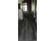 Hallway with wood-look flooring leading into a carpeted room at 1101 2Nd Ave. N # 306, Surfside Beach, SC 29575