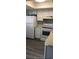 Kitchen features white appliances, white cabinets and new wood look flooring at 1101 2Nd Ave. N # 306, Surfside Beach, SC 29575