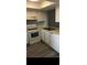 Bright kitchen features white appliances, white cabinets and a stainless steel sink at 1101 2Nd Ave. N # 306, Surfside Beach, SC 29575