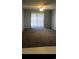 Living room with sliding glass doors to a balcony and a ceiling fan at 1101 2Nd Ave. N # 306, Surfside Beach, SC 29575
