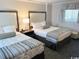 Cozy bedroom with two beds, lamp, and nightstand for a comfortable stay at 1105 S Ocean Blvd. # 136, Myrtle Beach, SC 29577
