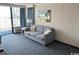 Cozy living room featuring a comfortable gray sofa and access to the outdoors at 1105 S Ocean Blvd. # 136, Myrtle Beach, SC 29577