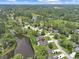 Gorgeous aerial view of a lakeside community featuring mature trees and stunning landscaping at 112 Birchwood Ln., Conway, SC 29526