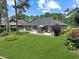 Charming home featuring a spacious back patio surrounded by a lush, landscaped yard at 112 Birchwood Ln., Conway, SC 29526