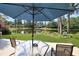 Relaxing backyard featuring a shaded patio set with peaceful pond views at 112 Birchwood Ln., Conway, SC 29526