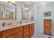 Double vanity bathroom with light wood cabinets, framed mirrors, and tiled floor at 112 Birchwood Ln., Conway, SC 29526